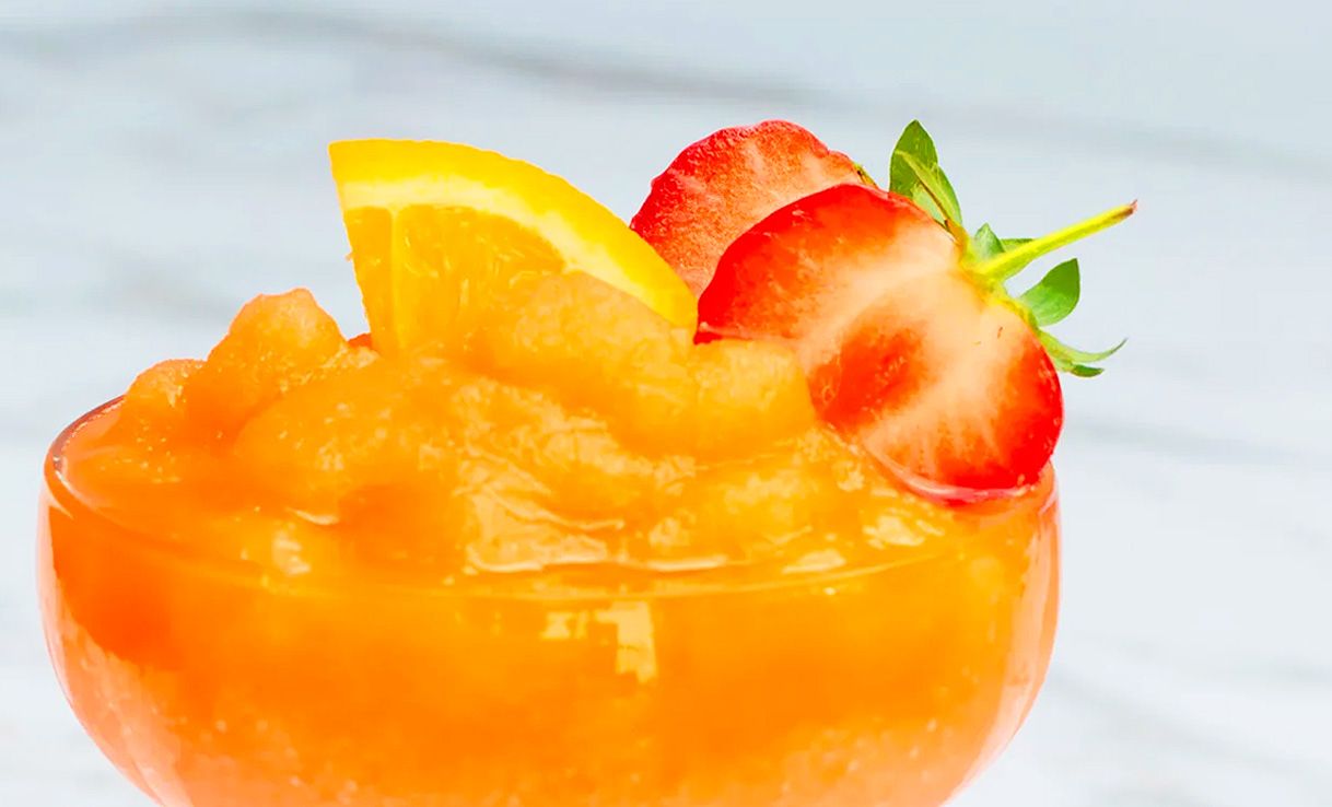 Glas mit Frozen Aperitivo und Zitrone sowie Erdbeere als Topping